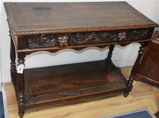 A 1920s carved oak hall table W.106cm